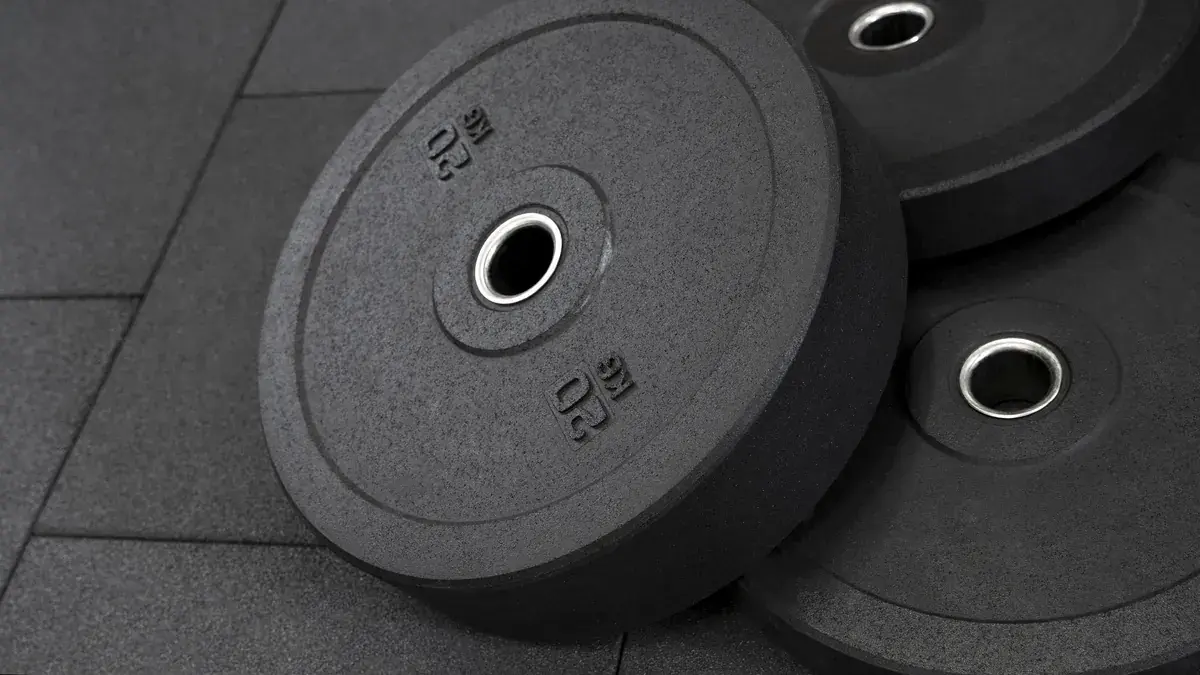 Rubber weight plates lying on a gym floor