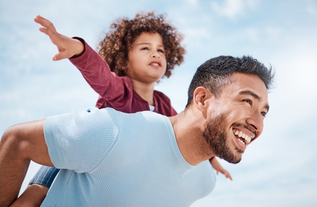 Father carrying child outdoors